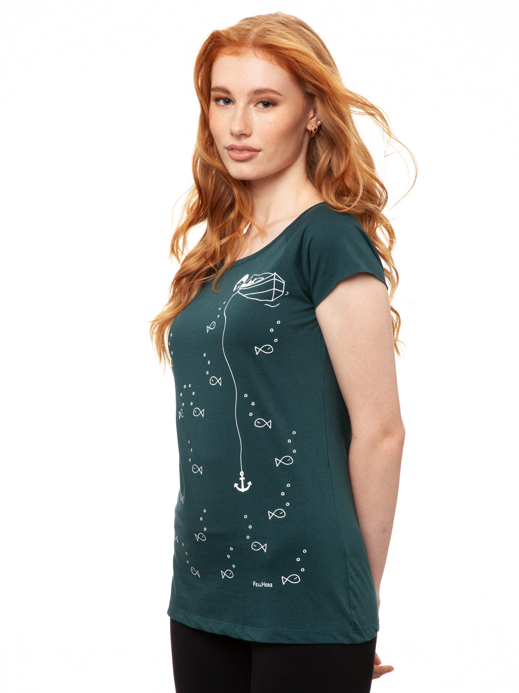 Ein Model trägt ein petrolfarbens Damen T‑Shirt aus 100 % Bio‑Baumwolle mit kurzen Cap‑Sleeves, maritimem Anker‑Siebdruck vorne und kleinem Logo‑Print auf dem Rücken – nachhaltig, fair produziert und lässig geschnitten