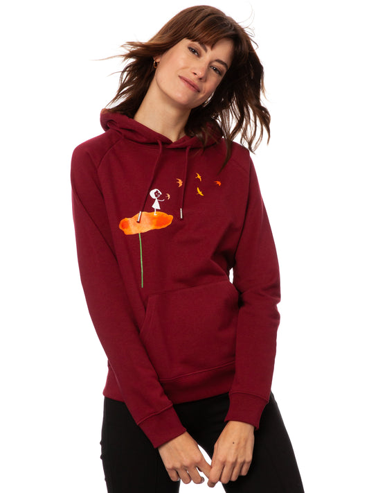 Dunkelroter damen kapuzen-pullover mit Bio-Baumwolle, nachhaltig, fair und vegan produziert. Raglan-Schnitt mit Grafik-Print auf der Vorderseite über der känguru-tasche: Ein Mädchen steht auf einer orangen Blume und es fliegen Vögel davon.